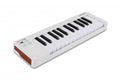 White MIDI keyboard controller with 25 keys, buttons, and sliders with wood side panels