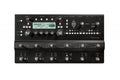 Black guitar effects unit with multiple knobs, foot switches, and a digital display showing 'Atomic Punch'.