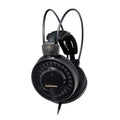 Black over-ear wired headphones with visible branding and mesh ear cup covers.