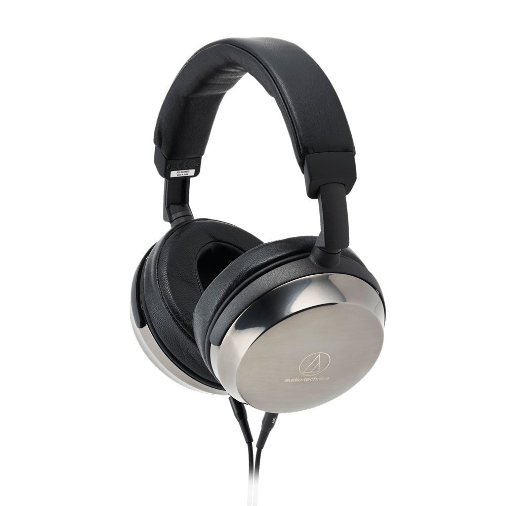 Over-ear headphones with black leather ear pads and silver metal outer ear cups with the audio-technica logo