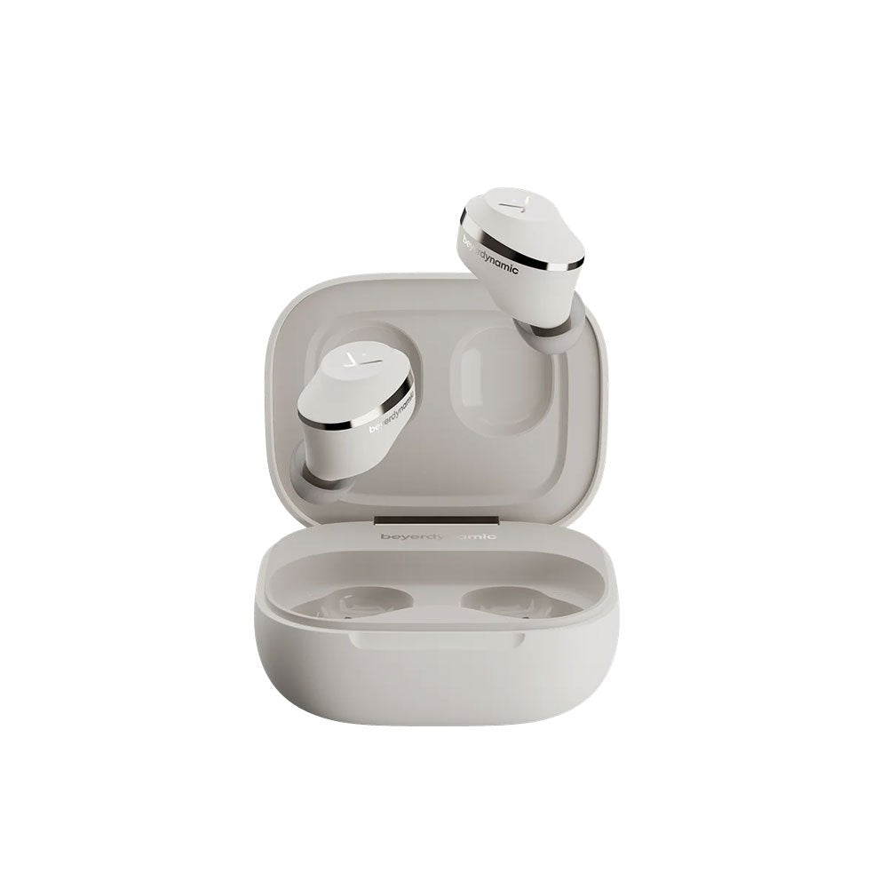 Cream-colored true wireless earbuds with charging case and silver trim displayed on white background.