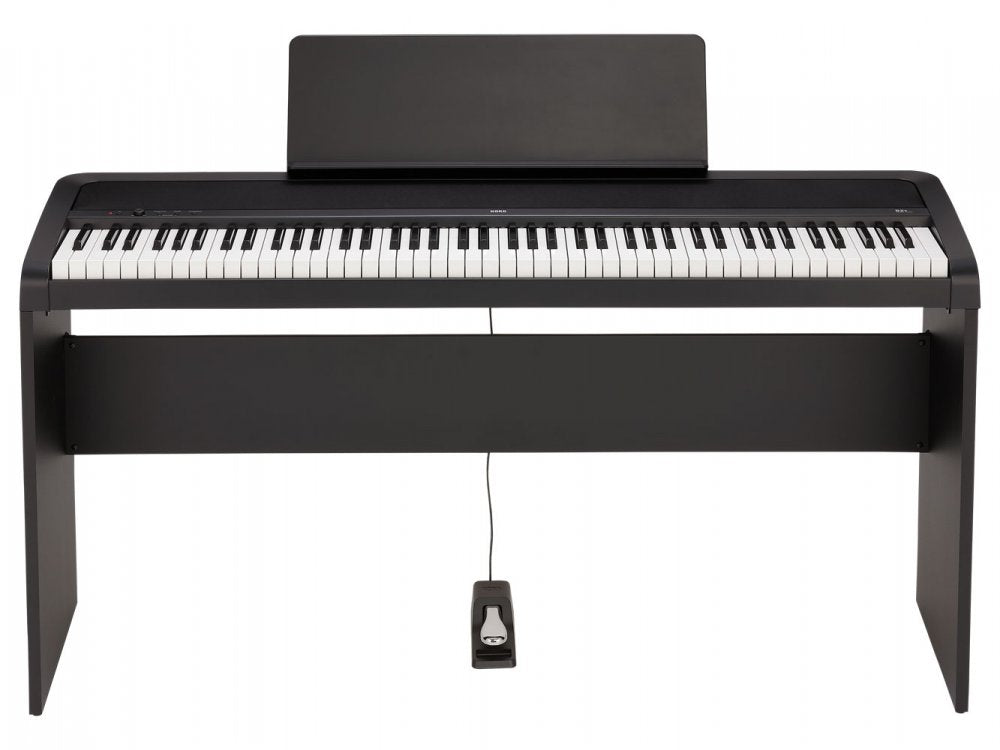 Black digital piano keyboard with 88 keys, wood stand, music rest, and sustain pedal.
