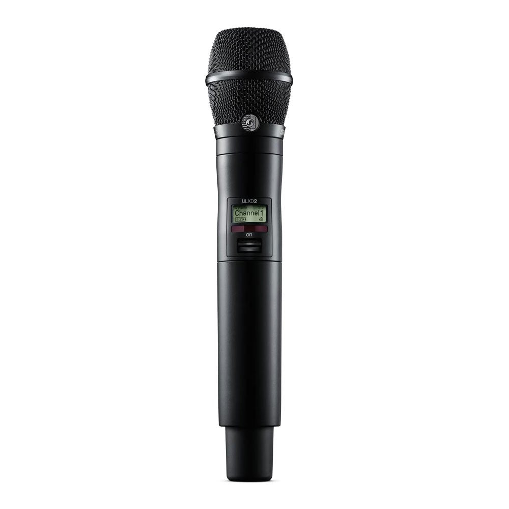Black handheld wireless microphone with a mesh head and digital display showing channel information.
