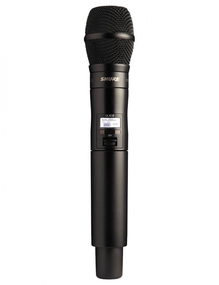 Black handheld wireless microphone with mesh grille and LCD screen displaying frequency and battery level.