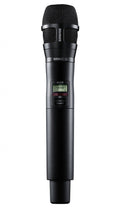 Black handheld wireless microphone with mesh grille and display showing Channel 1