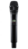 Black handheld wireless microphone with mesh grille and digital display showing channel information.