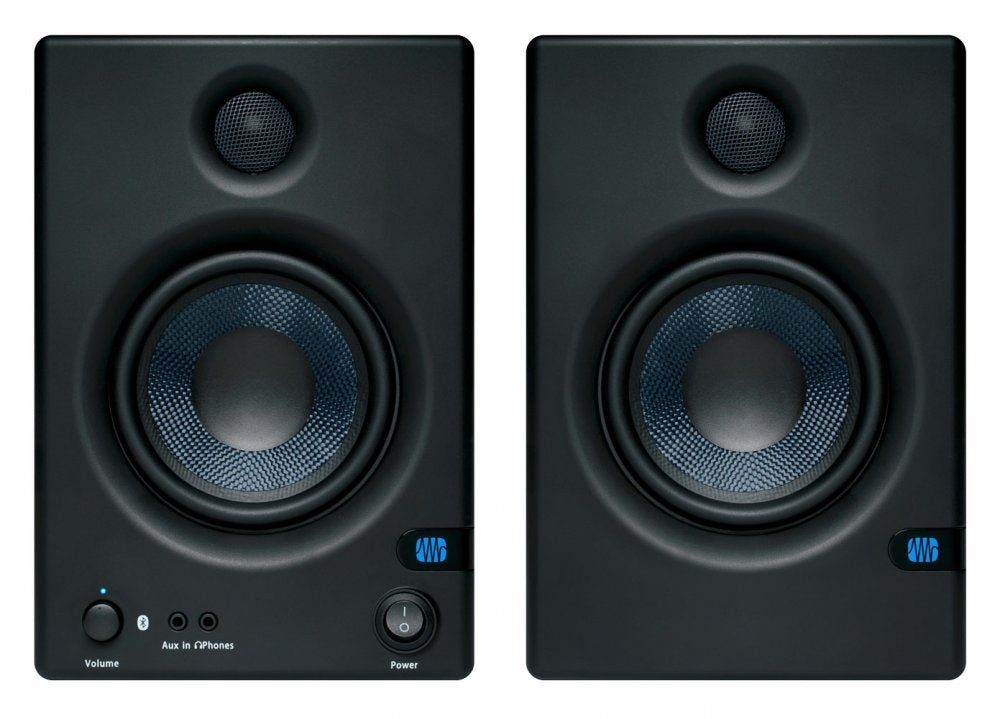 Front view of two black studio monitor speakers with blue cones and control knobs on left unit.