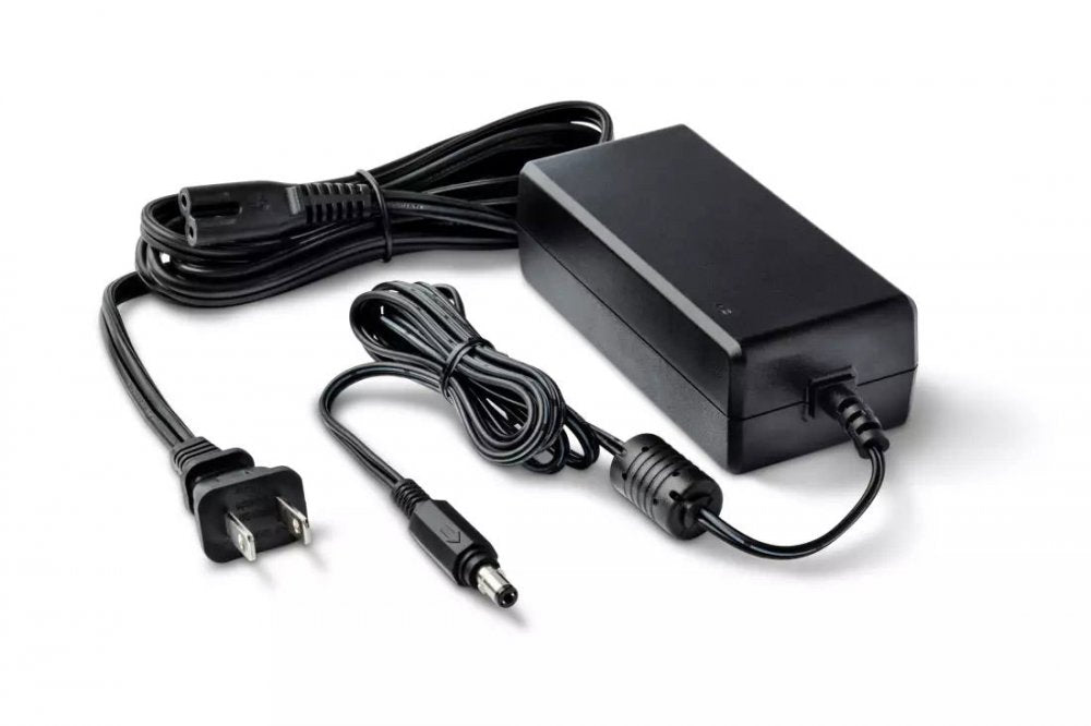 Black power adapter brick with AC power cord and DC barrel connector cable on white background.