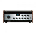 Black and silver audio device with knobs, toggle switch, and multiple jack inputs, featuring wooden side panels.