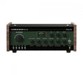 Black and vintage green audio effects unit with multiple knobs, switches, jacks, and wooden side panels.