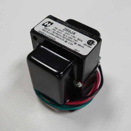 Black power transformer with attached red and green insulated wire leads and a label showing electrical specifications.
