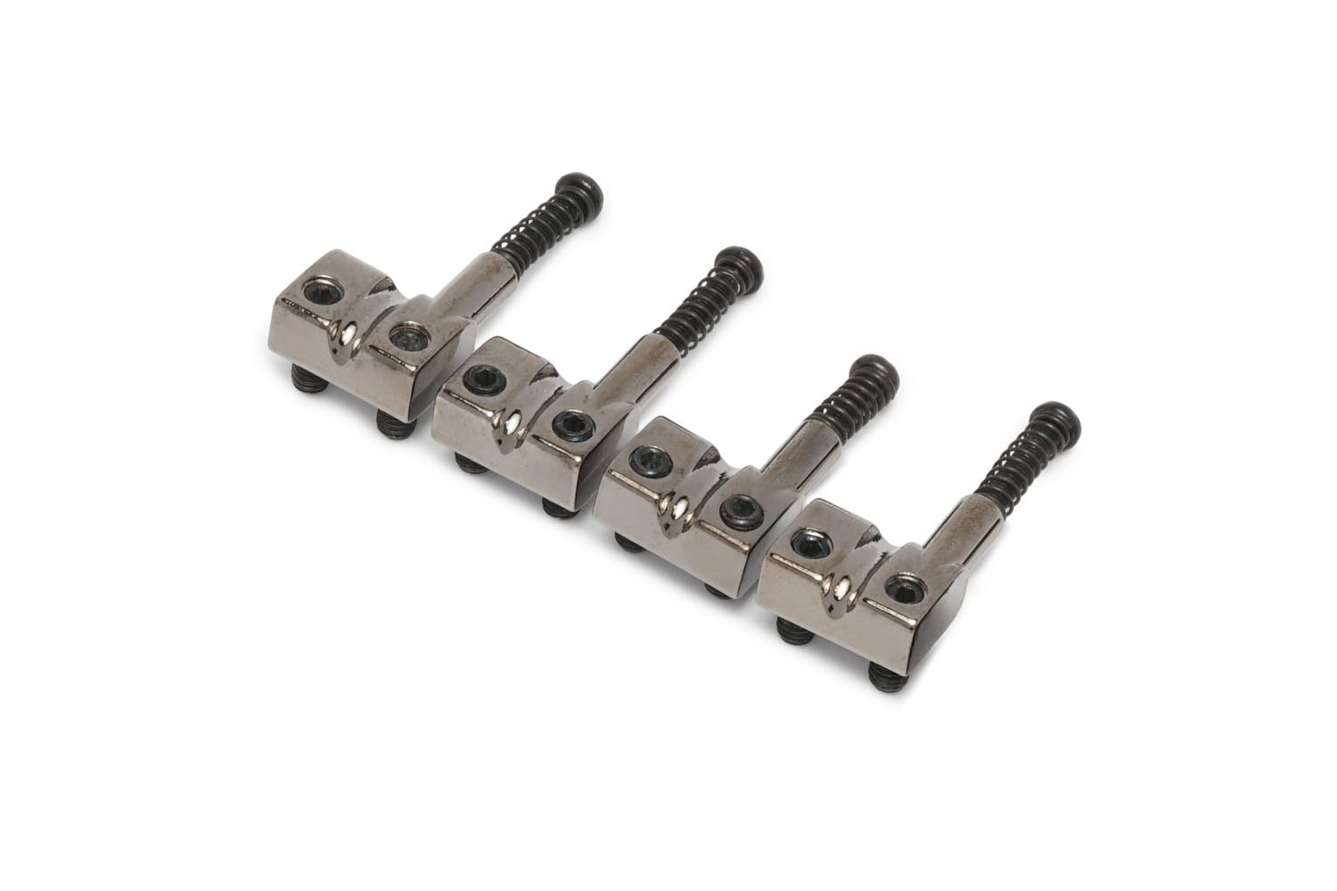 Four silver metal bass guitar saddles with screws arranged in a row on a white background.