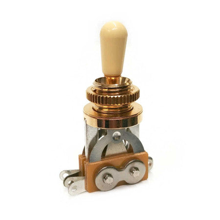 Gold toggle switch with ivory-colored tip and metal connectors on a white background
