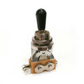Metal toggle switch with black plastic tip and solder lugs on beige base