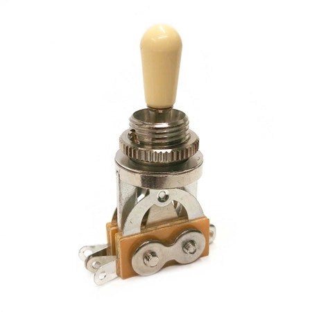 Nickel metal toggle switch with ivory plastic tip and terminal lug connectors on a tan base.