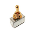 Metal toggle switch with a gold-colored lever on a silver rectangular base.