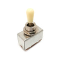 Metal toggle switch with an ivory-colored plastic tip on a rectangular metal base.