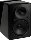 Black studio monitor speaker with two drivers and a small control knob on the front panel.