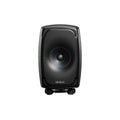 Front view of a black Genelec studio monitor speaker with a visible driver and green indicator light on a small adjustable stand.