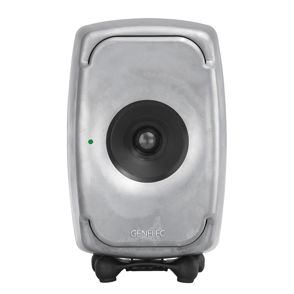 Front view of a silver studio monitor speaker with a central black driver and green indicator light.