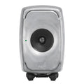 Front view of a silver studio monitor speaker with a central black driver and green indicator light.