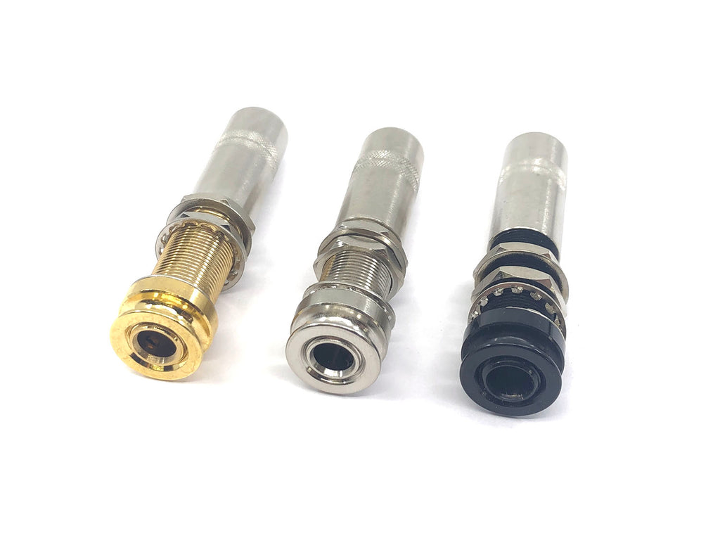 Three metal female audio jack connectors in gold, silver, and black on a white background.