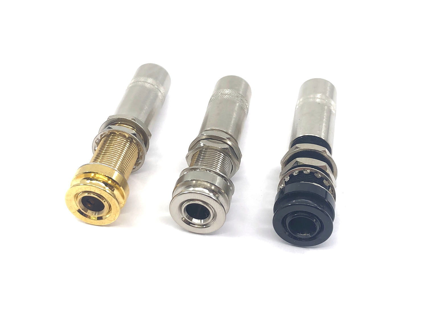 Three metal female audio jack connectors in gold, silver, and black on a white background.