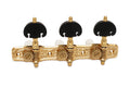 Set of three gold-colored classical guitar machine heads with black tuning keys mounted on an ornate gold base plate.