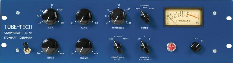 Blue audio compressor unit with multiple black knobs, toggle switches, and a VU meter on the front panel.