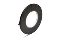 Roll of black cloth tape with a small loose end against white background.