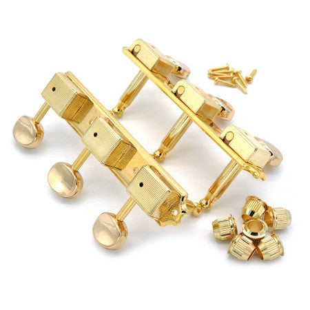 Gold-colored 3-on-a-plate guitar tuners with bean-shaped buttons and mounting screws shown on white background.