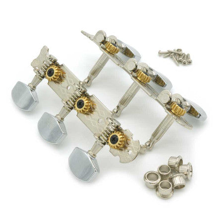 Three-on-a-strip guitar tuning machines with large silver knobs, gold gear wheels, screws, and bushings on a white background.