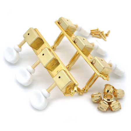 Two sets of gold 3-on-a-plate guitar tuners with white buttons, screws, and washers on a white background.