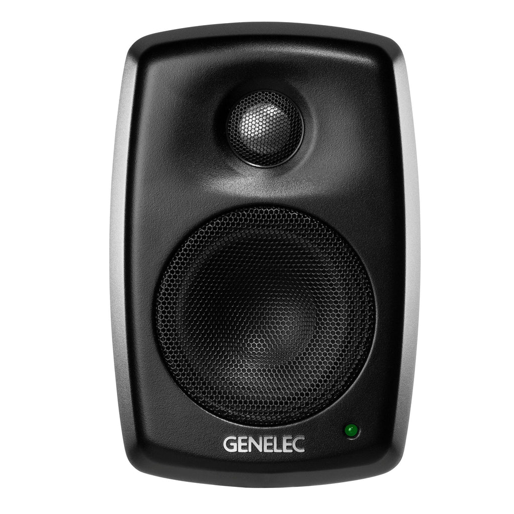 Front view of a black Genelec studio monitor speaker with metal mesh over drivers and a green indicator light.