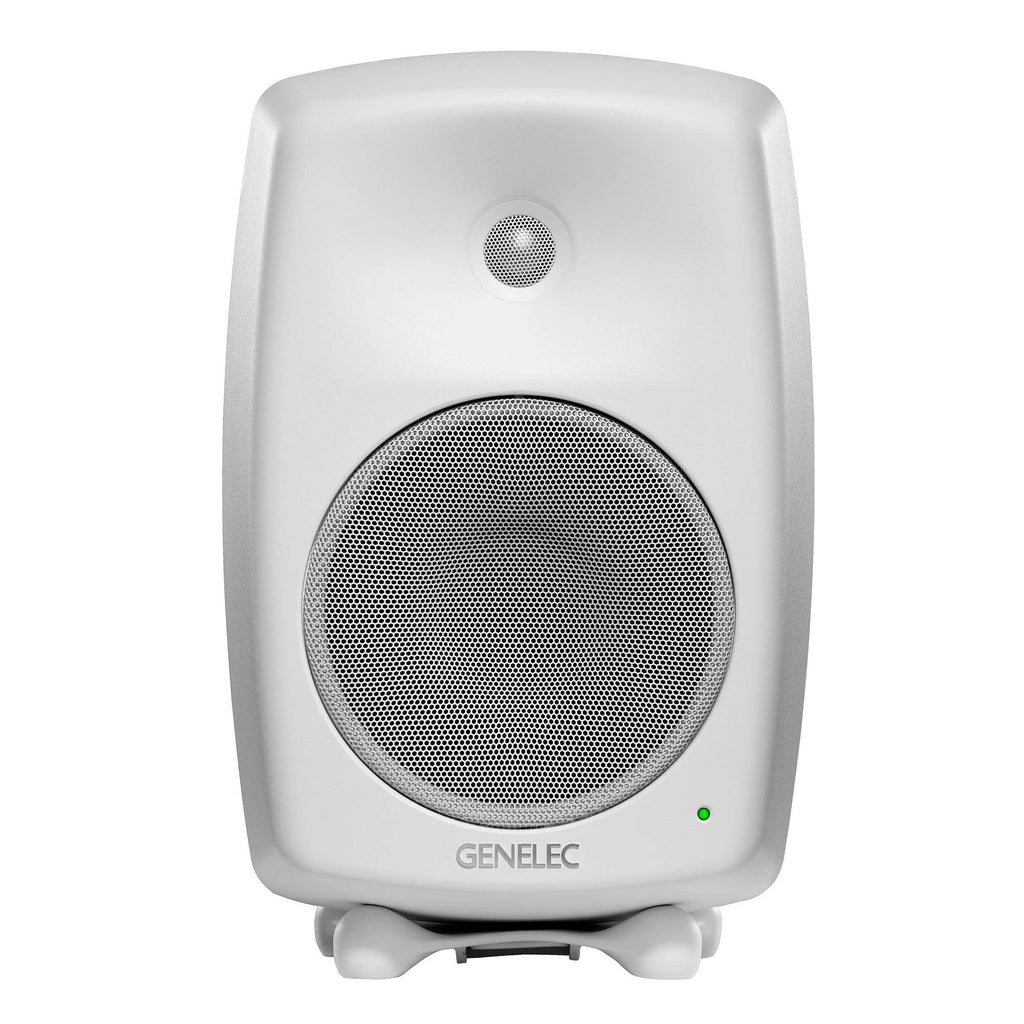 White studio monitor speaker with front metal speaker grilles and a green indicator light lit.