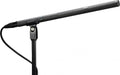 Black shotgun microphone mounted on a stand with attached cable and XLR-type connector.