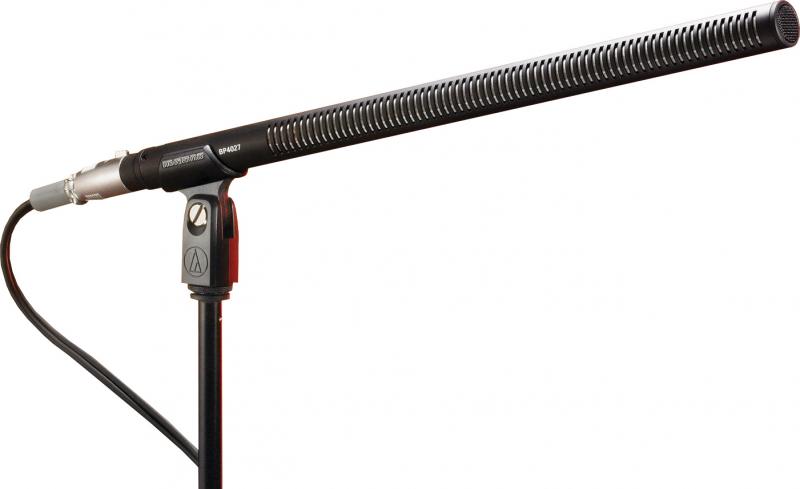Black shotgun microphone labeled BP4027 on a stand with XLR connector and attached cable.