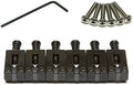 Six black metal guitar saddles with screws and a hex key wrench for adjustment.