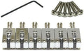 Set of six metal guitar saddles with screws and an Allen wrench on a white background