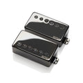 Two black EMG guitar pickups with six pole pieces each, shown on a reflective white surface.