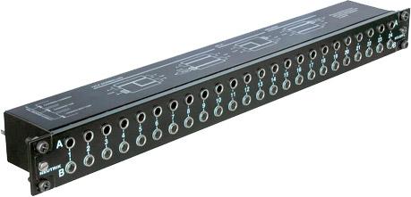 Black metal audio patchbay with multiple 1/4 inch jacks and rotary switches labeled A and B.