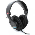 Black over-ear wired headphones with padded headband and ear cups showing Sony branding and model number MDR-7506.