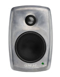 Front view of a gray Genelec studio monitor speaker with two speaker drivers and a green indicator light.