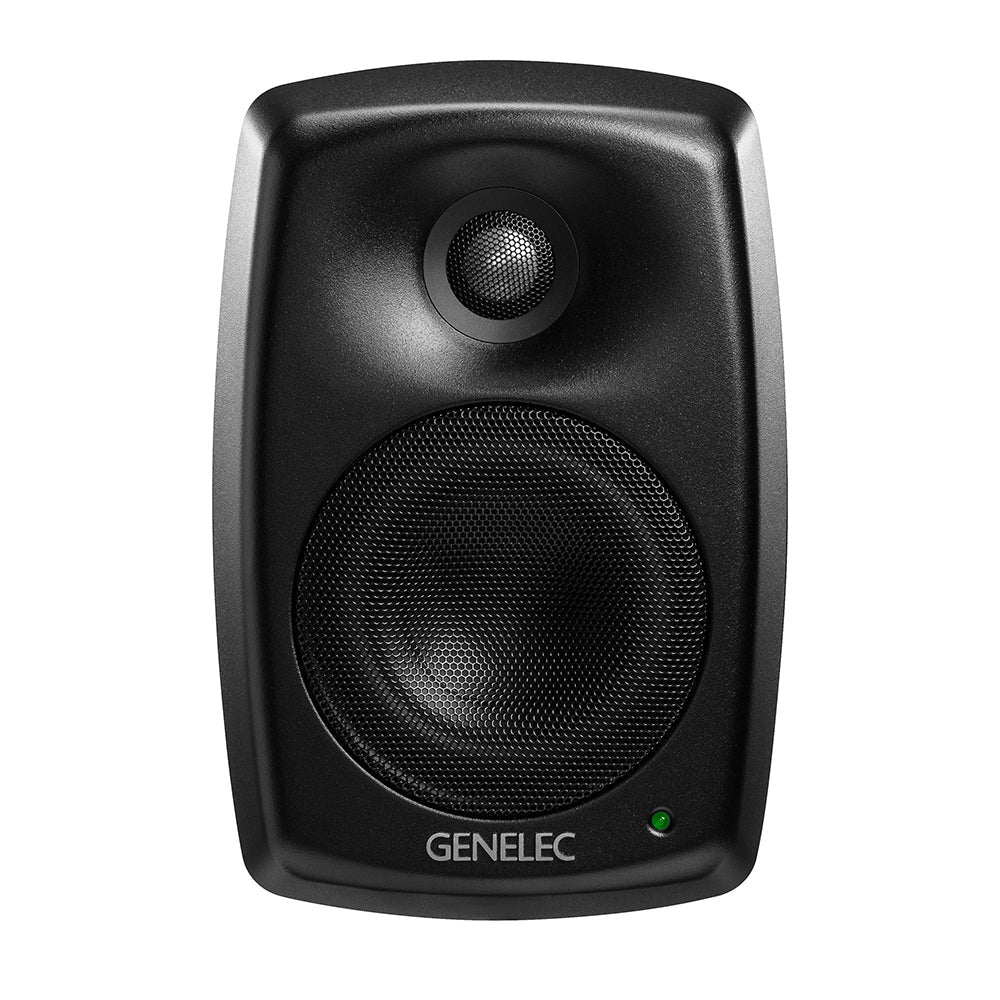 Black studio monitor speaker with a metal mesh woofer and tweeter and a green indicator light.