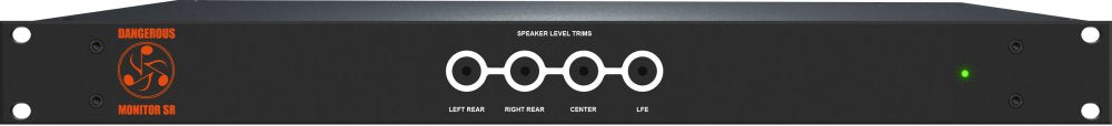 Black rackmount audio device with rotary knobs labeled for speaker level trims and a green status LED.