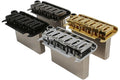 Three metal guitar bridge assemblies in black, silver, and gold finishes are shown side by side.