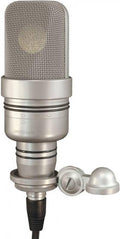 Silver studio microphone with mesh grille, control markings, and attached mounting hardware with cap