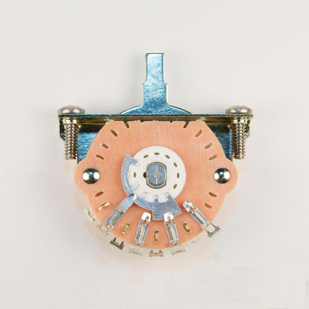 Top view of a tan and silver multi-connector lever switch with five solder lug terminals.