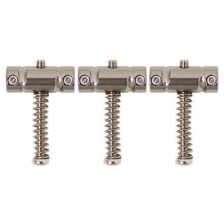 Three silver metal saddles with springs and adjustment screws arranged side by side on a white background.