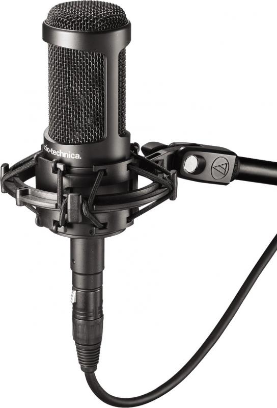 Black Audio-Technica microphone in a shock mount with cable attached.